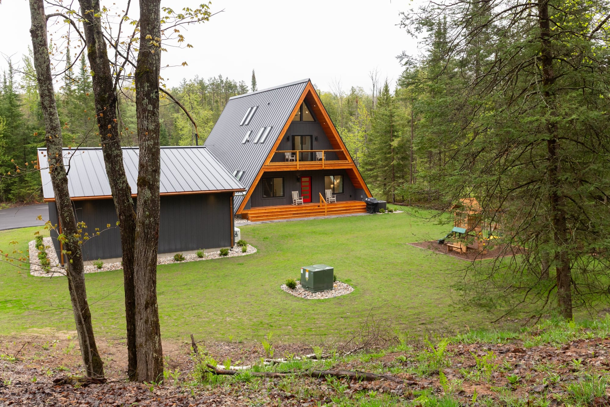 The A-frame across the clearing, with the firepit in the foreground
