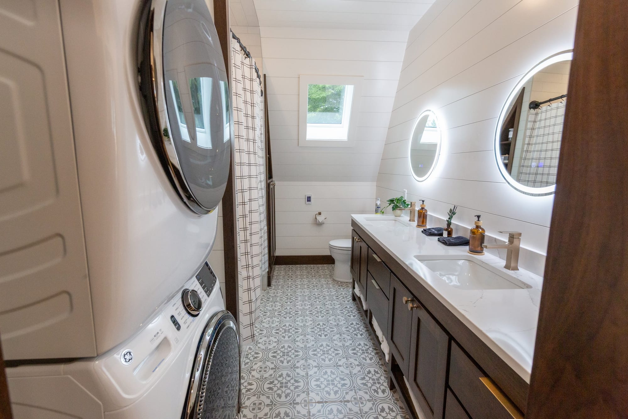 Bathroom with a double vanity and round mirrors