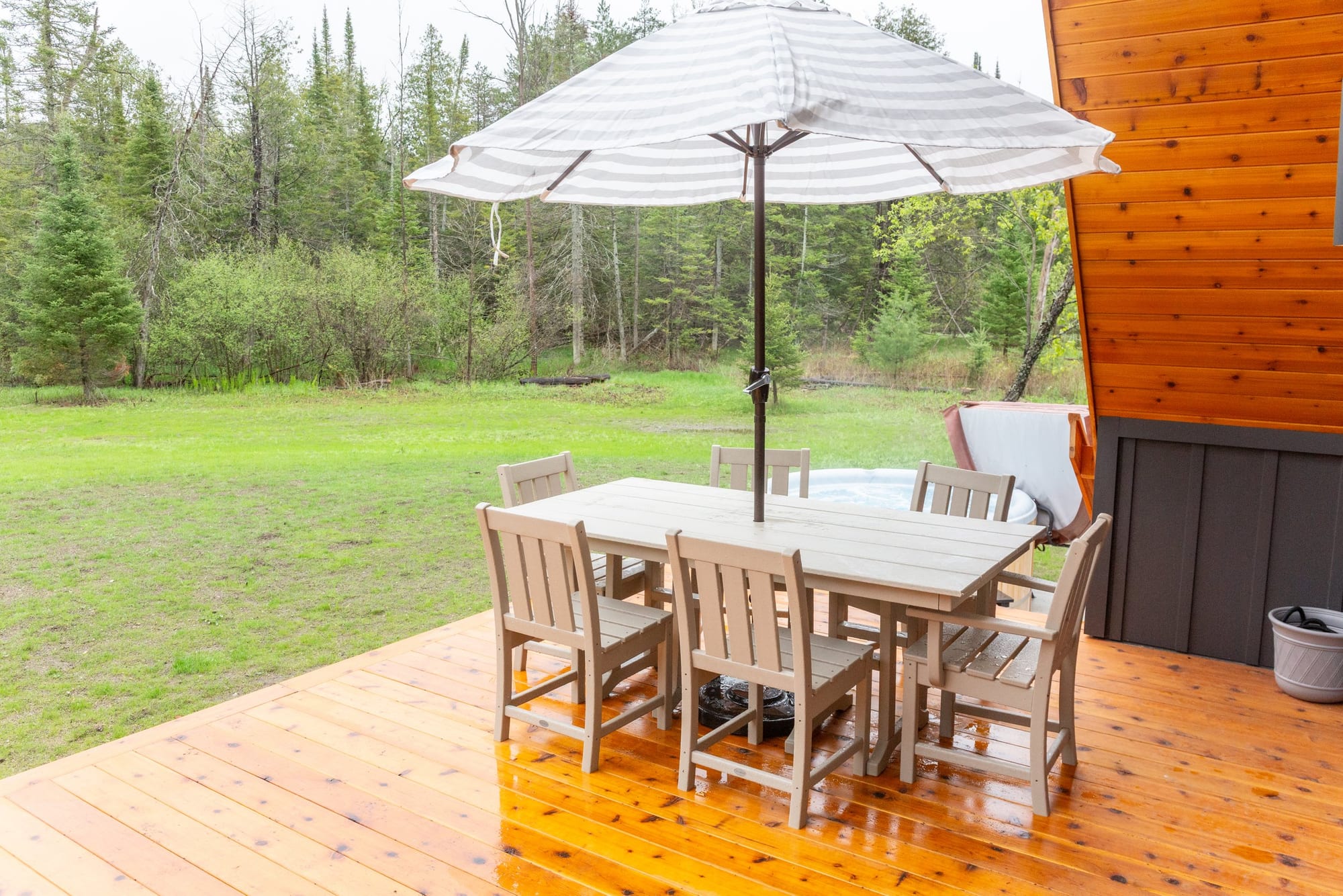 Outdoor dining table under an umbrella on the deck