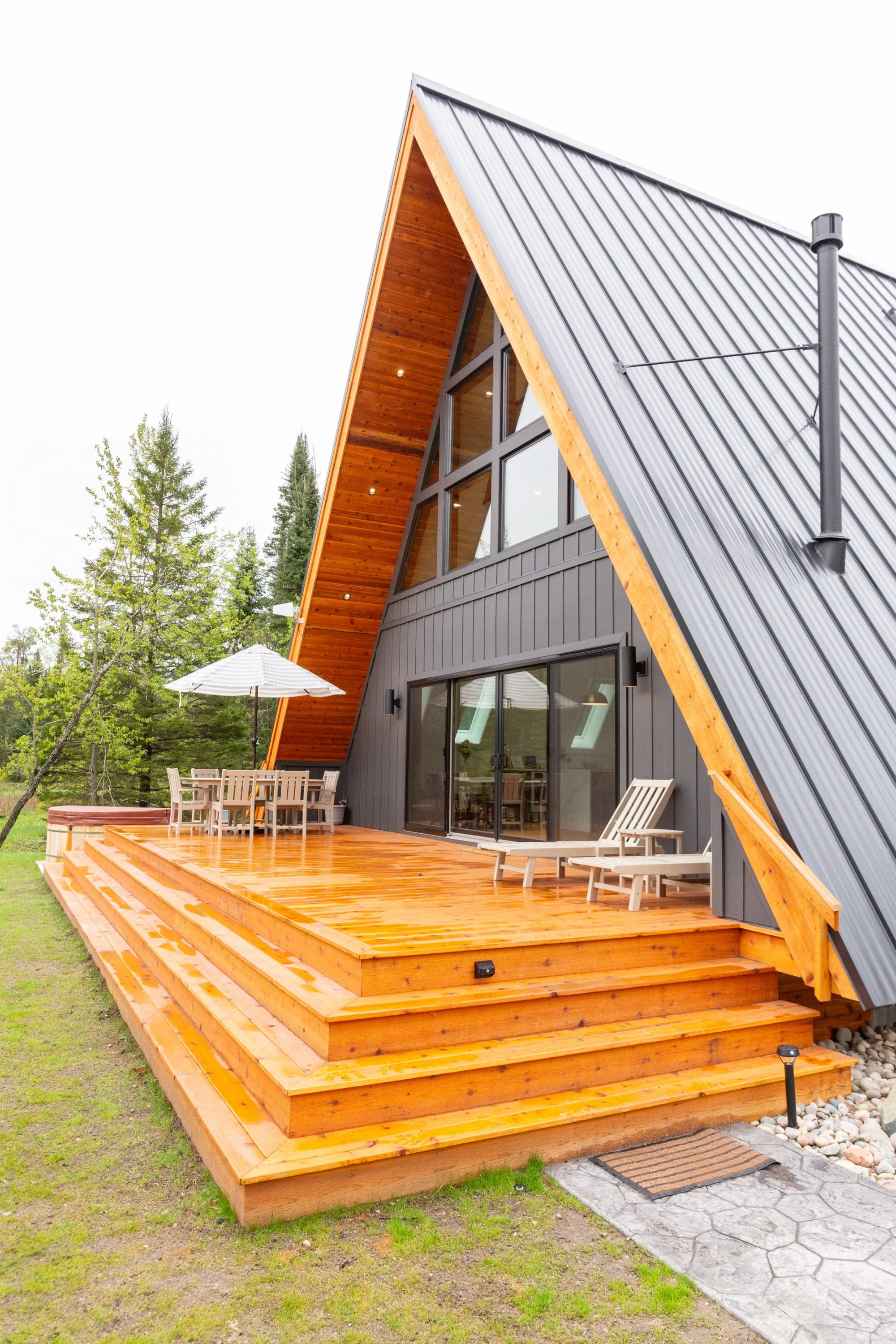 The cedar deck wrapping the gable end of the house