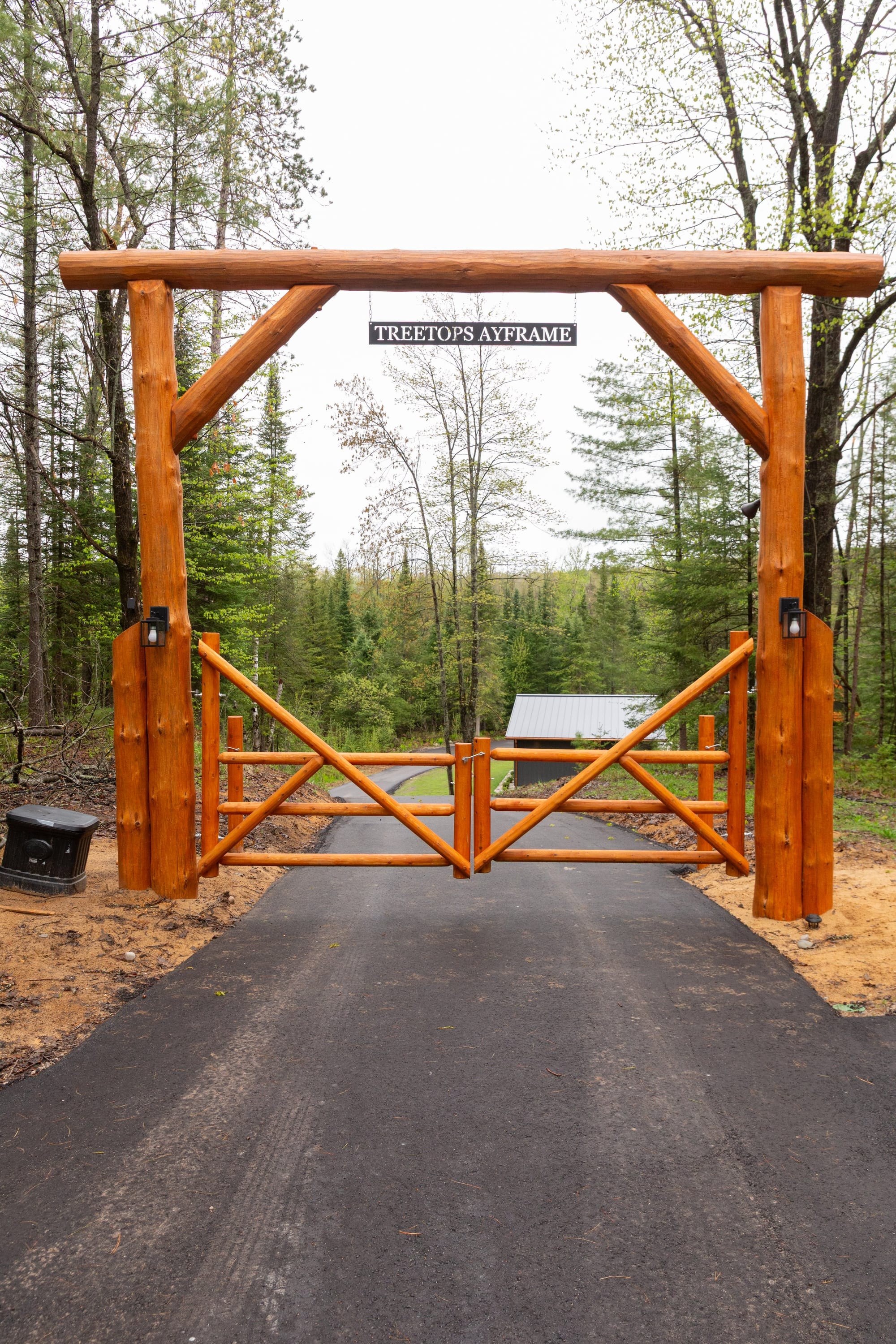 The timber entrance gate at the head of the drive