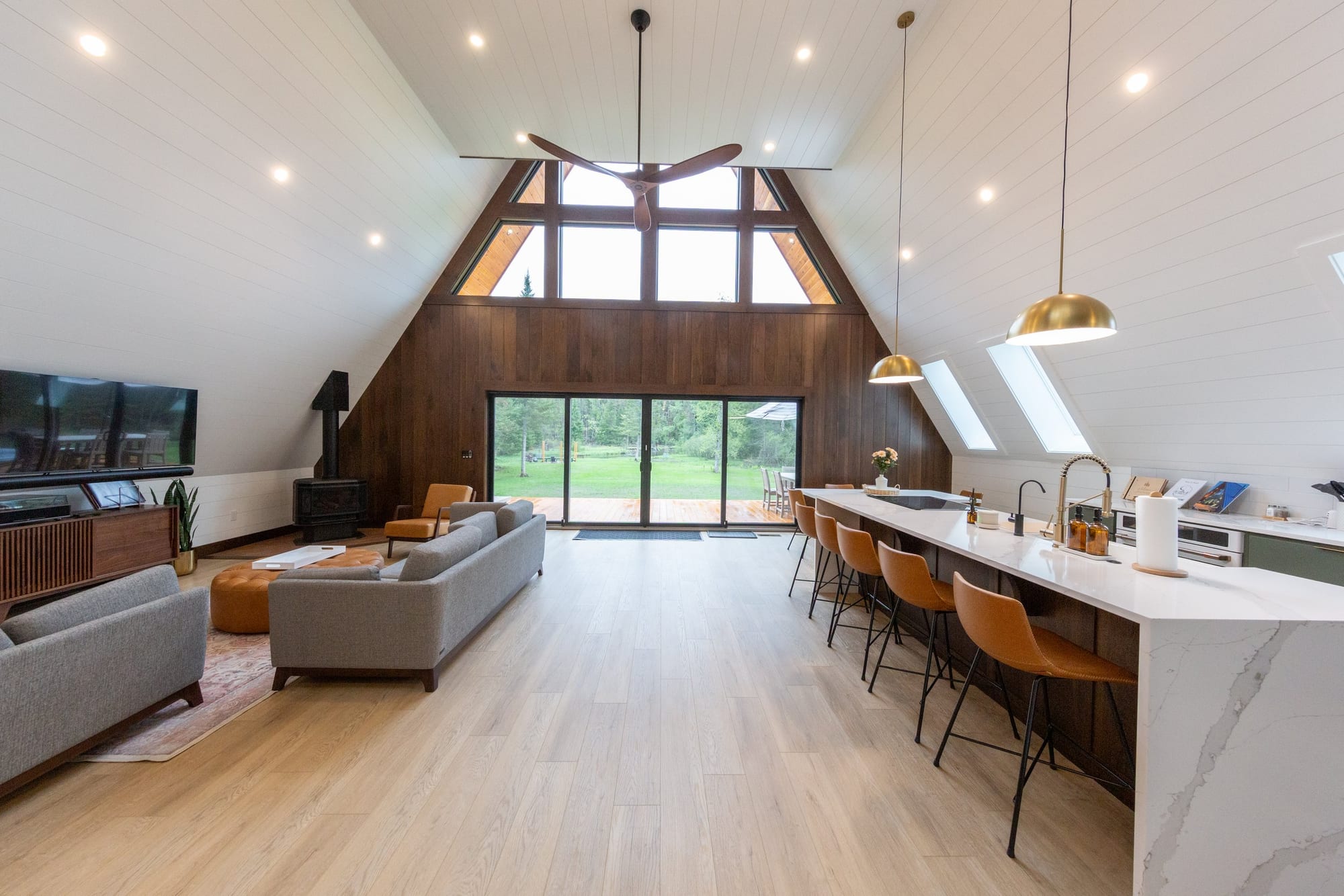The great room under the full height of the roofline, open to the kitchen