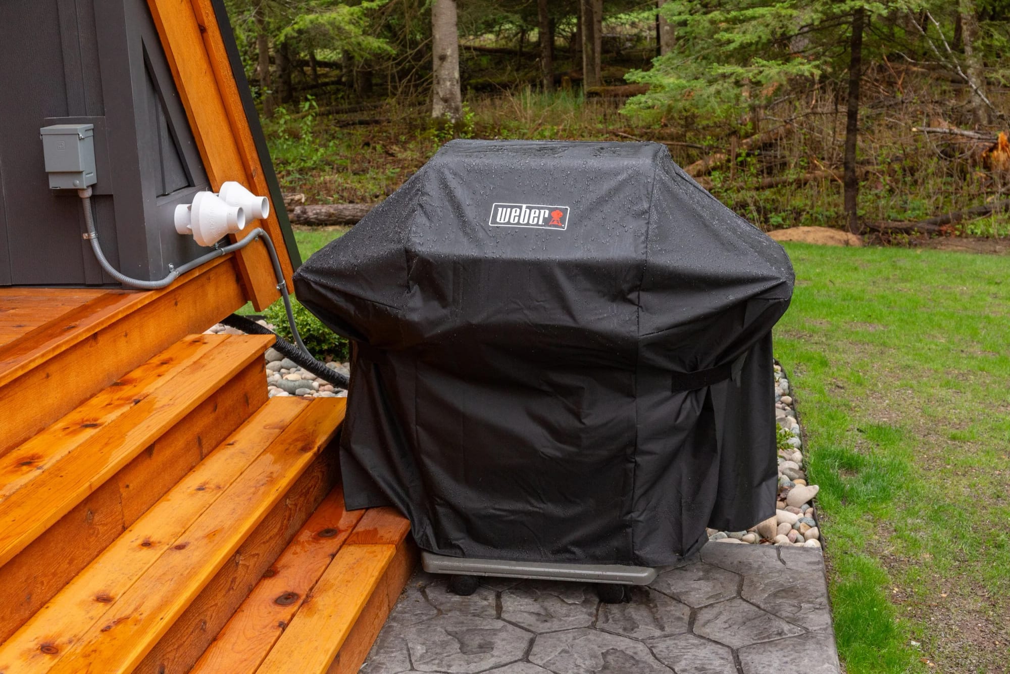 The gas Weber grill beside the deck steps