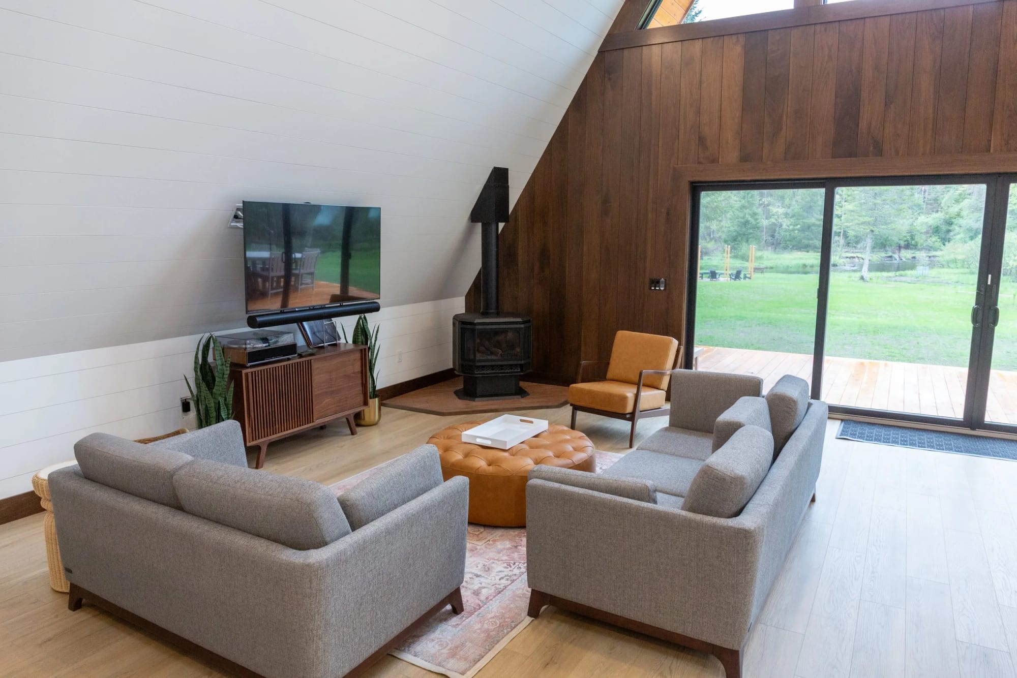 The sitting area with the smart TV and walnut wall